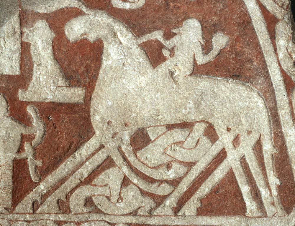 Gotland picture stone from Tjängvide: a rider on an eight-legged horse received by a woman with a drinking horn