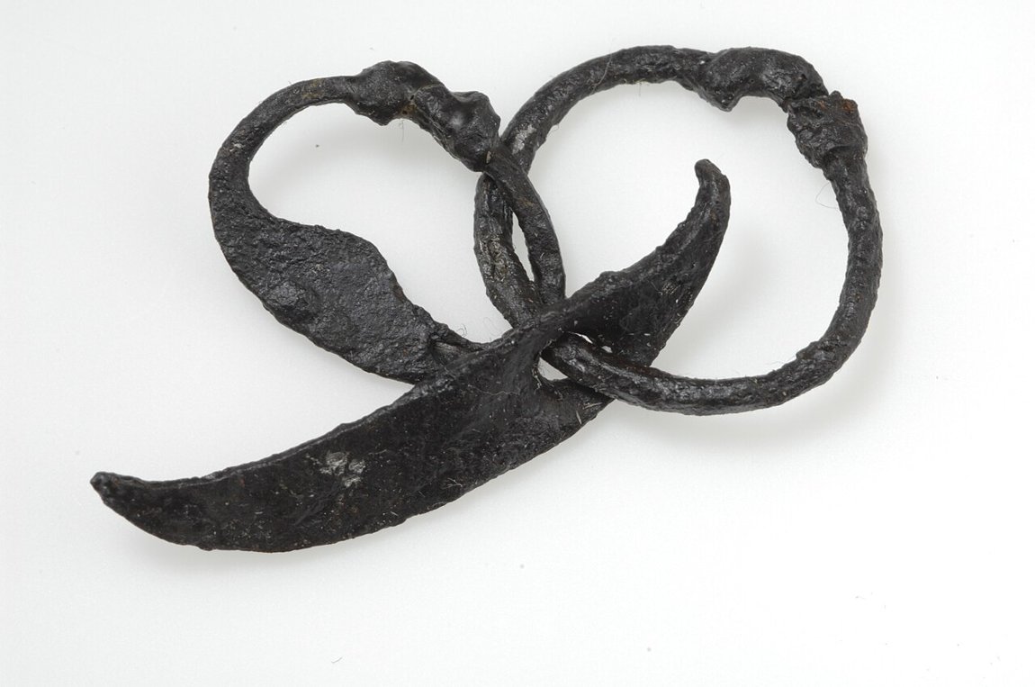 Iron amulet with fire steel and sickle — the sickle was the central harvest tool of the Viking age.